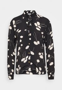 Blusa nera a maniche lunghe con motivo floreale bianco, collo mao, chiusura con bottoni e bottoni color oro, con un fiocco al collo.