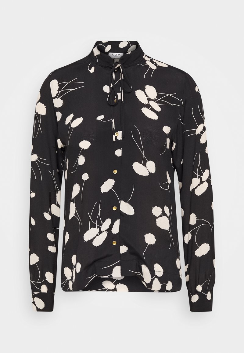 Blusa nera a maniche lunghe con motivo floreale bianco, collo mao, chiusura con bottoni e bottoni color oro, con un fiocco al collo.