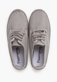Gray canvas shoes with round toe, lace-up design, metal eyelets, and rubber soles. Features a textured finish and logo detail inside.