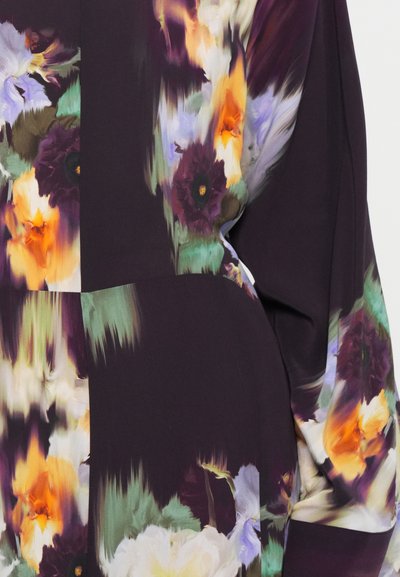 Long-sleeve blouse featuring a vibrant floral print with purple, orange, and green hues, made from lightweight fabric with a smooth texture.