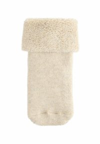 Cremefarvet uldstrømpe med tyk, fluffy kant foldet ned, tekstureret blødt strikket stof, isoleret på hvid baggrund.