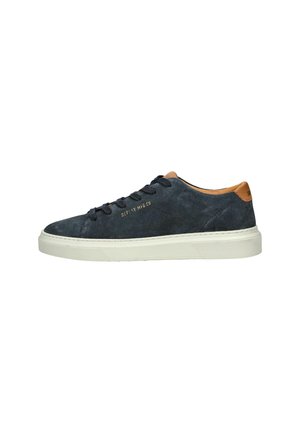Suede sneakers in dark navy with white rubber sole. Features brown leather accents on the heel and a textured finish. Lace-up design.