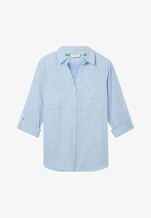 Hellblaues Langarmhemd aus strukturiertem Stoff. Verfügt über zwei Brusttaschen und hochrollbare Ärmel, die mit einer Lasche gesichert sind. Knopfverschluss vorne.