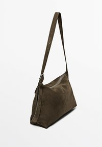 Brown suede crossbody bag with an adjustable strap, zipper closure, and a soft texture. Features a simple, angled design.