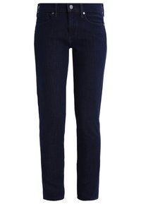 Tummansininen farkkuhousut slim fit -mallissa, jossa on viisi taskua, etupainikekiinnitys ja näkyvät saumat.