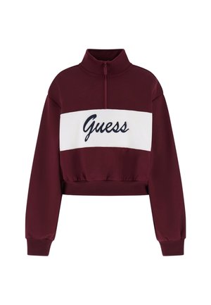 Felpa corta bordeaux con colletto alto, caratterizzata da un bordo bianco con il logo "Guess" in blu navy, e vita e polsini elasticizzati.