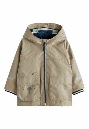 Beige kinderjas met capuchon en voorsluiting met rits, twee grote zakken, waarvan één met een berengezicht en oren, en gestreepte manchetdetails.