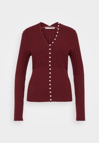 Viininpunainen ribbisvillapaita pitkillä hihoilla, V-pääntiellä ja koristeellisilla nappeilla edessä. Pehmeä tekstuuri, istuva malli.