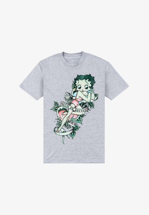 Camiseta de algodón gris con una ilustración de Betty Boop rodeada de hojas, un corazón y el texto "Consiénteme hasta el hartazgo" en un estilo retro.