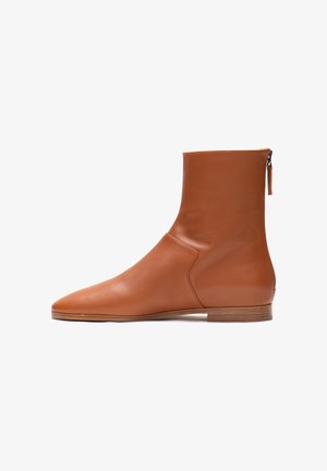 Brown leather ankle boot with a sleek design, pointed toe, and a side zipper. The sole is flat with a slightly textured finish.
