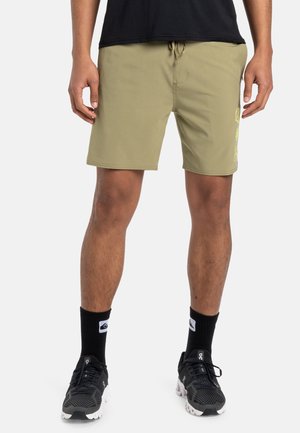 Khaki swim shorts in a smooth fabric, featuring a drawstring waist and side pocket with bright yellow graphic detailing on the left leg.