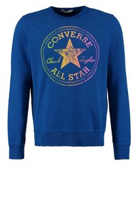 Sweat-shirt bleu en coton à manches longues. Présente un logo étoile coloré et le texte "Converse Chuck Taylor All Star" sur le devant.