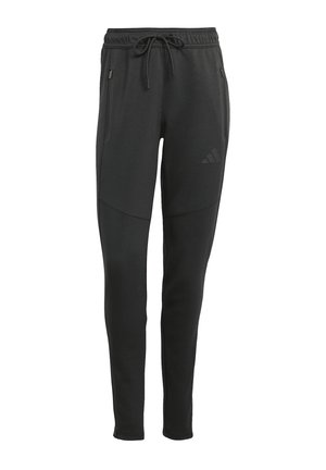 Jogging athlétique noir avec taille à cordon, poches latérales zippées et logo discret sur la cuisse gauche, jambes fuselées et détails de coutures.