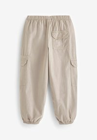 Beige cargo bukser med elastisk talje, elastiske manchetter og to sidelommer. Blødt bomuldsmateriale med en glat tekstur.