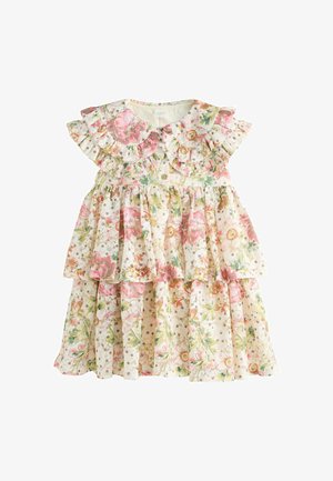 Lysefarvet blomster-toddler-kjole med lagdelte flæser, korte ærmer og små brune prikker over hele stoffet.