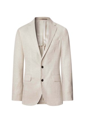 Blazer beige texturé avec deux poches avant et deux boutons noirs. Présente un motif subtil et une doublure intérieure en satin léger.