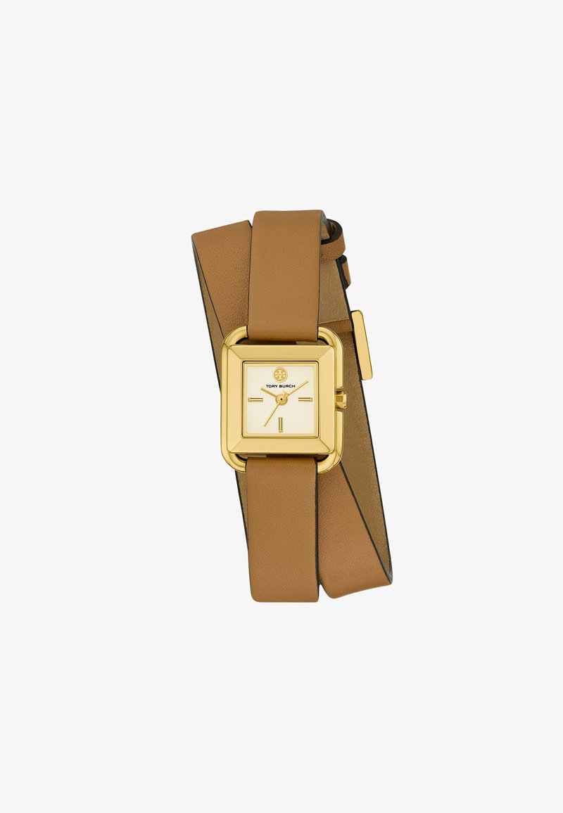 Montre carrée en or avec un cadran crème et deux bracelets en cuir tan. Les caractéristiques incluent un matériel en or et un cadran minimaliste avec des indices fins.