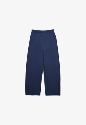 Marinblå vidbyxade byxor i mjukt tyg med elastisk midja och två sidofickor med ren, enkel sömnad.