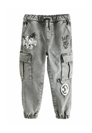 Pantalon cargo gris avec taille et poignets élastiques, décoré de dessins graffiti représentant un crâne, une couronne, un smiley et du texte sur les jambes avant.