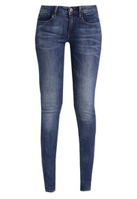 Jeans skinny de denim azul con un lavado desgastado, diseño tradicional de cinco bolsillos y cierre de botón metálico en la cintura.