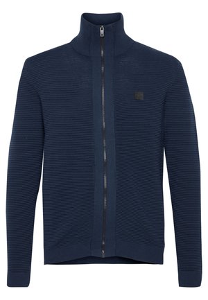 Marineblaue Zip-up-Jacke aus strukturiertem Strickmaterial, mit hohem Kragen, gerippten Bündchen und kleinem Logo auf der Vorderseite.