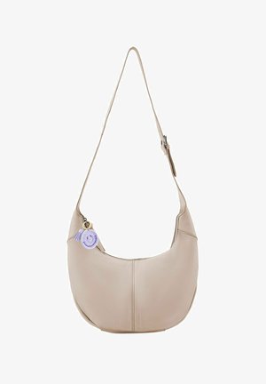 Beige leather shoulder bag with a curved, soft shape. Features a decorative purple tassel and charm attached to the zipper. Adjustable strap.