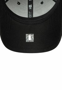 Schwarz Käppi mit strukturiertem Design und flachen Schirm. Das Innere hat eine graue Futterung und ein kleines Logo-Patch in der Mitte.