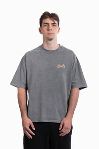 Gray oversized t-shirt made of cotton, featuring short sleeves, a round neck, and a subtle graphic in light brown on the chest.