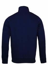 Námořnicky modrá bunda na zip s vysokým límcem, dlouhými rukávy a žebrovanými manžetami. Má bílé dekorativní pruhy podél ramen.