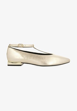 Ballerines métalliques dorées avec un bout pointu, une bride à la cheville et un petit talon carré accentué en or. Texture lisse, design minimaliste.