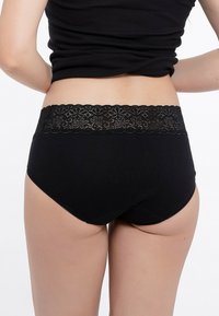 Slip neri in cotone con una cintura in pizzo floreale, texture liscia, design alto in vita e un'apertura per la gamba curvata per un fit confortevole.