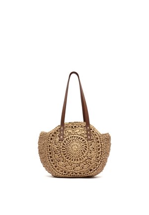 Sac à main rond en paille tissée avec des bandoulières en cuir marron, avec un motif circulaire et un design à tissage ouvert.