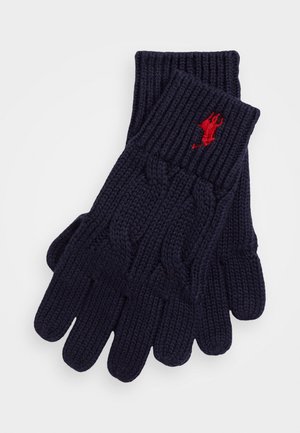 Marineblaue gestrickte Handschuhe mit einem strukturierten Zopfmuster und gerippten Bündchen, verziert mit einem kleinen roten Logo im Handgelenkbereich.