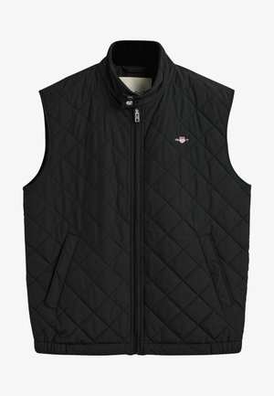 Gilet matelassé noir avec un col montant, fermeture éclair sur le devant, deux poches latérales et un petit logo sur la poitrine. Texture lisse.