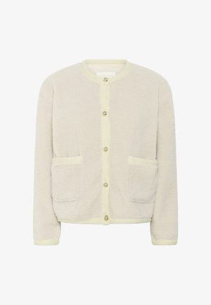 Ihanteellinen kerros verrattuna pehmeästä kermansävyisestä neuleesta, jossa on vaaleankeltaiset reunat, kaksi etutaskua ja pyöreä nappisulku. Pehmeä rakenne, rento muotoilu.