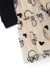 Sweatshirt mit schwarzen Stoffärmeln, kombiniert mit einem cremefarbenen Tülloverlay, das schwarze bestickte Mickey-Maus- und Schleifenmuster zeigt.