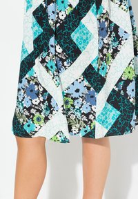 Kukkakuosiset hameet, joissa on tilkkutäkki-design sinisen, vihreän ja mustan sävyissä. Pehmeää kangasta kevyellä tuntumalla ja liehuva helma.