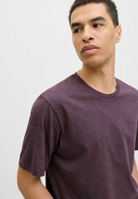 Maroon cotton t-shirt with a crew neckline and short sleeves, featuring a smooth texture and relaxed fit. No patterns or hardware present.