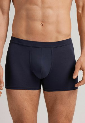 Boxer-briefs bleu marine en tissu lisse, dotés d'une poche à l'avant, d'une taille élastique et de coutures plates pour un confort et un ajustement optimal.