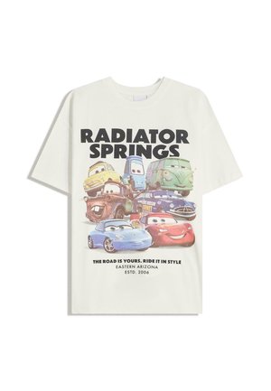 White cotton t-shirt featuring a graphic with animated cars. Text reads "RADIATOR SPRINGS" and "THE ROAD IS YOURS. RIDE IT IN STYLE."