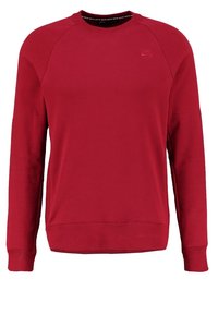 Röd Nike-tröja med långa ärmar, rund halsringning och ribbade muddar. Har en liten logotyp på övre vänstra bröstområdet.