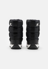 Black padded winter boots with a textured rubber sole, featuring a logo on the back and pull tabs for easy wear.