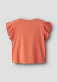 T-shirt corail à manches courtes avec des manches en dentelle à œillets festonnés. Tissu en coton doux, coupe décontractée et encolure arrondie.