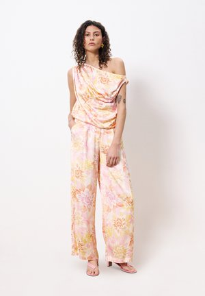 Floral, off-shoulder top in pink and yellow hues with draped design; wide-leg trousers with similar floral pattern; light fabric; soft texture.