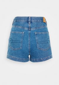 Denim shorts in light blue, featuring a high waist, two back pockets, straight hem, and a small leather brand tag on the back waistband.