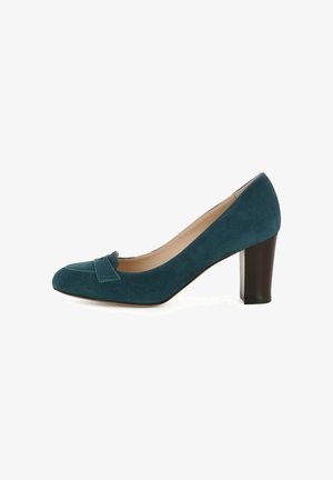 Escarpin en daim bleu sarcelle avec un bout arrondi et un nœud décoratif à l'avant. Il présente un talon noir épais de hauteur moyenne. Doublure intérieure lisse.