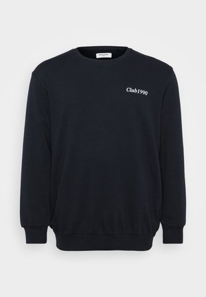 Sort sweatshirt med lange ærmer, ribbede manchetter og kant. Har hvid tekst "Club1990" på brystet. Fremstillet af blødt, struktureret stof.