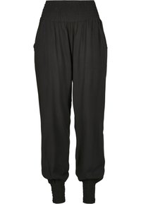 Pantalons noirs à taille élastique avec poches latérales, poignets froncés et tissu léger, offrant une coupe décontractée et fuselée.