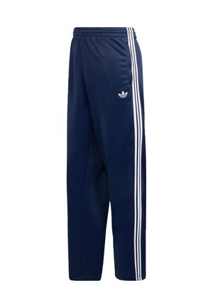 Tmavomodré tepláky z hladkej tkaniny, s tromi bielymi pruhmi po stranách a malým logom na stehne. Elastický pás.