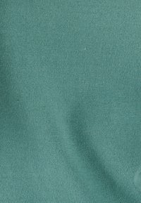 Tissu côtelé teal avec une texture lisse, présentant un motif uniforme de lignes verticales et une légère élasticité.